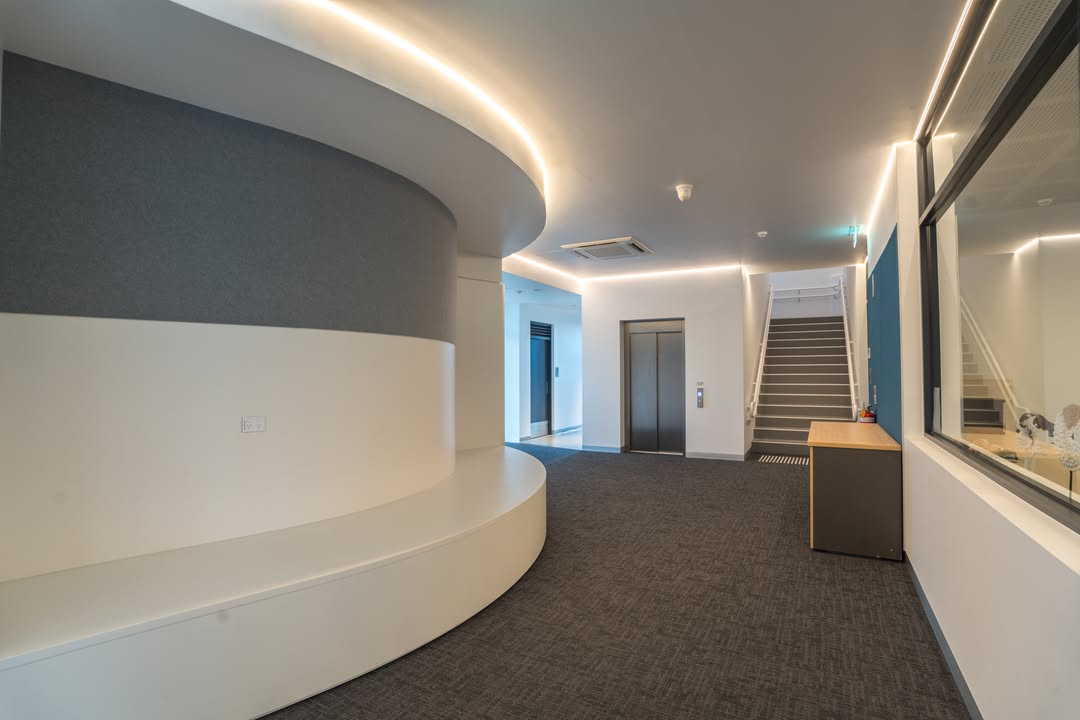 Modern hallway with recessed lighting and high ceilings